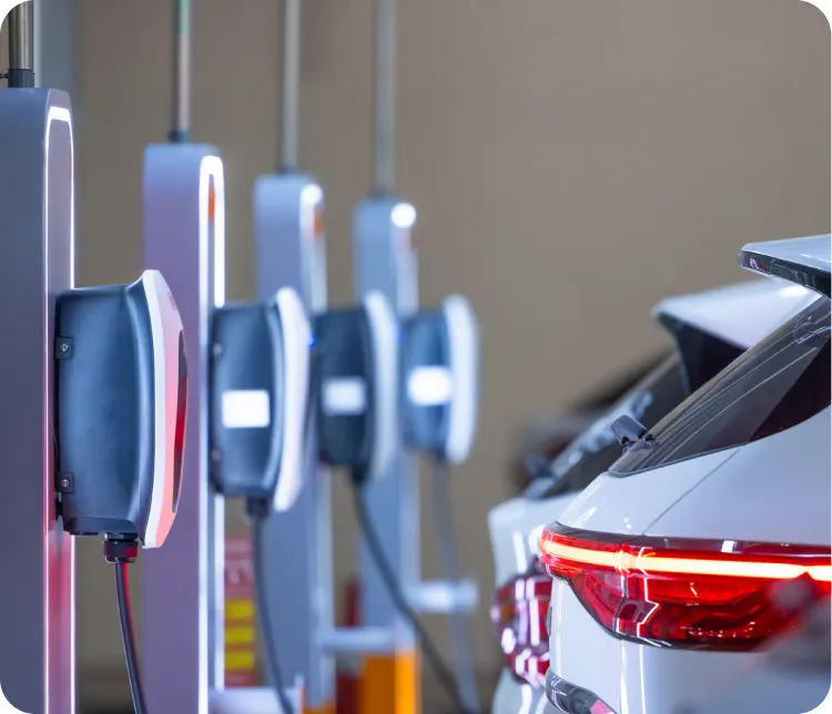 Wall chargers mounted along the parking spaces of a residential garage