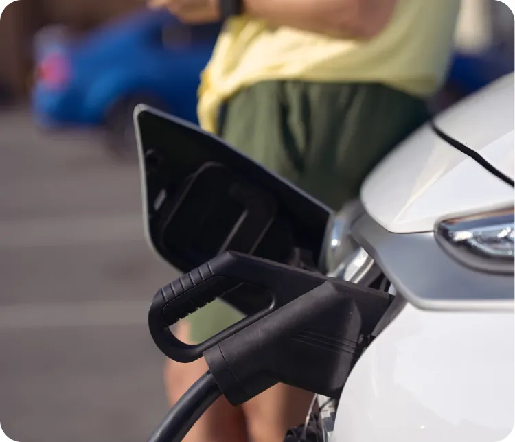A charging cable connected to an electric car at a shared residential charger